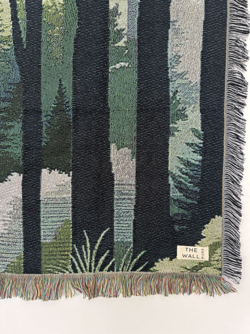 A wall rug with a verdant forest