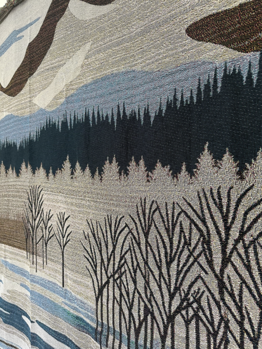 A wall rug with a mountain landscape